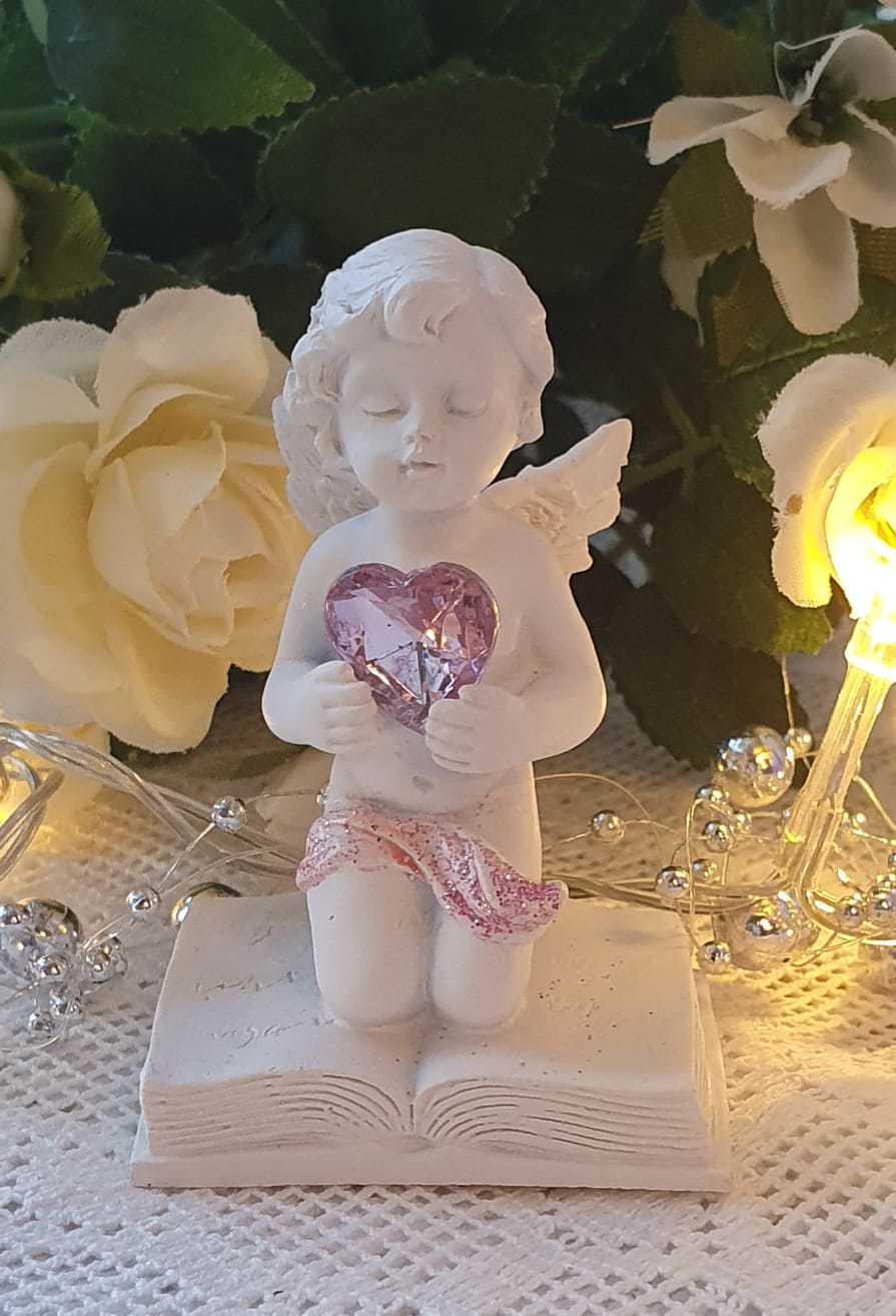 Ängel På Bok Med Rosa Hjärta