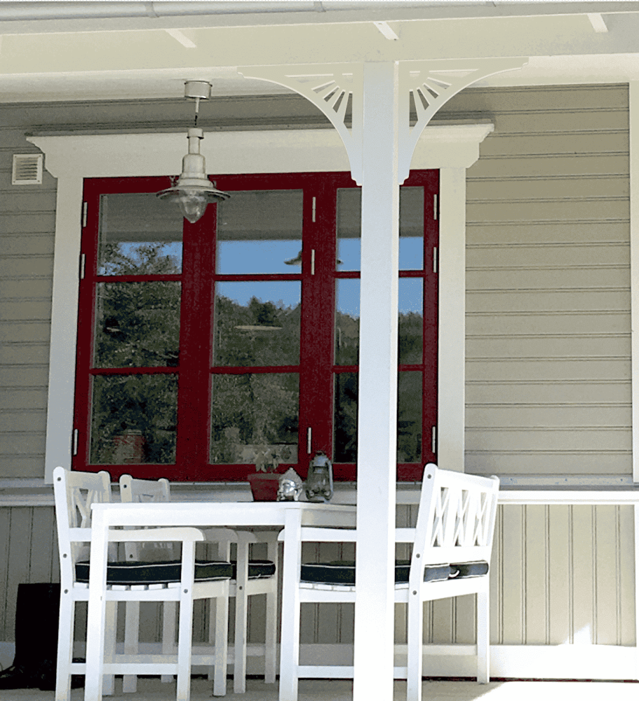 A beautiful grey porch in New England style with a decorative wooden bracket 061