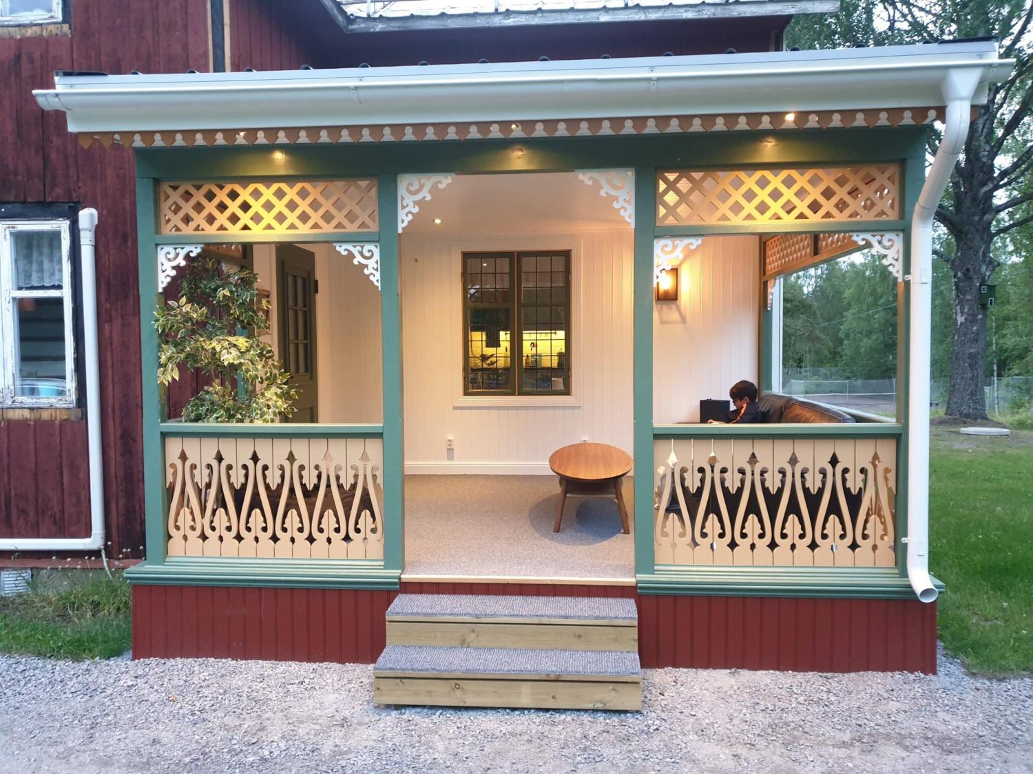 A Swedish green porch with yellow house decoration