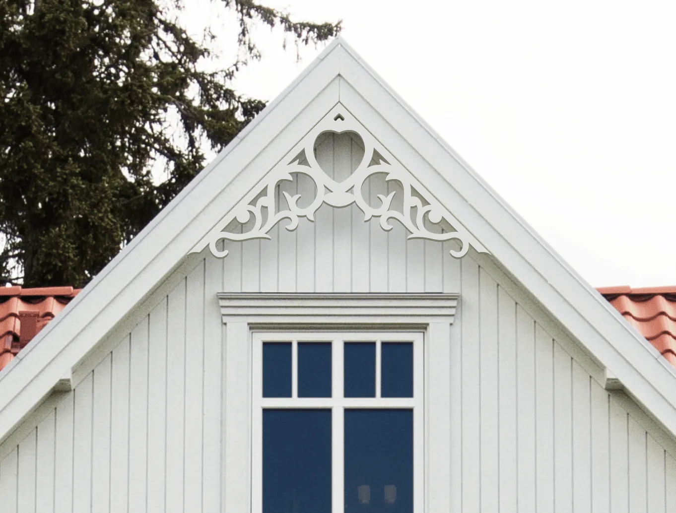 Gable pediment 002 - A white house with decorative wooden victorian millwork as house decoration for roof and gable end.