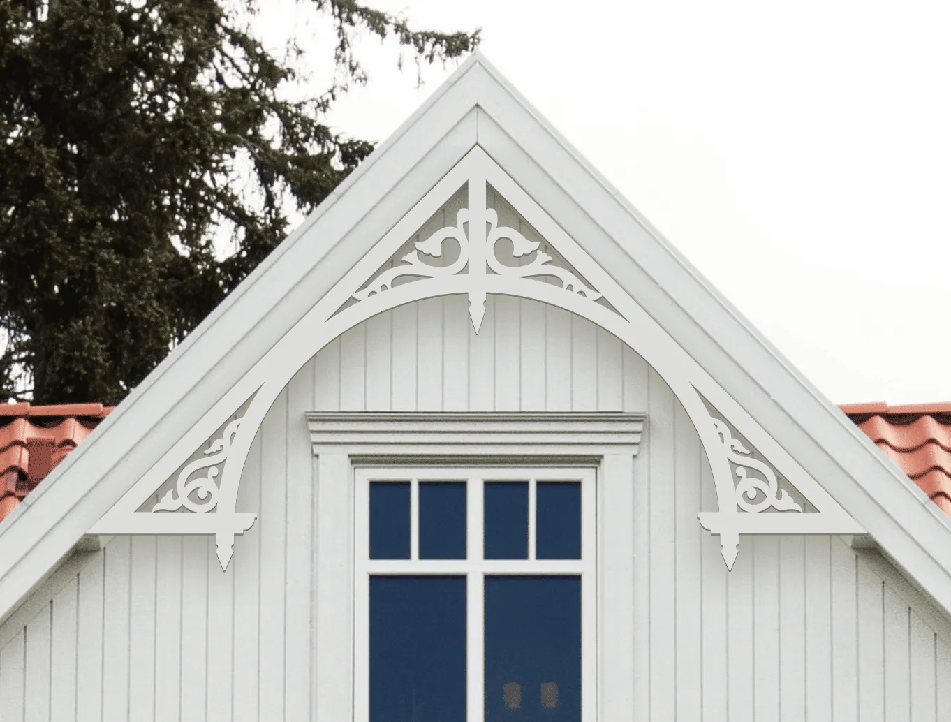 Gable pediment 050 - A white house with decorative wooden victorian millwork as house decoration for roof and gable end.