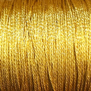 Glittrande guldtråd 1,2 mm.