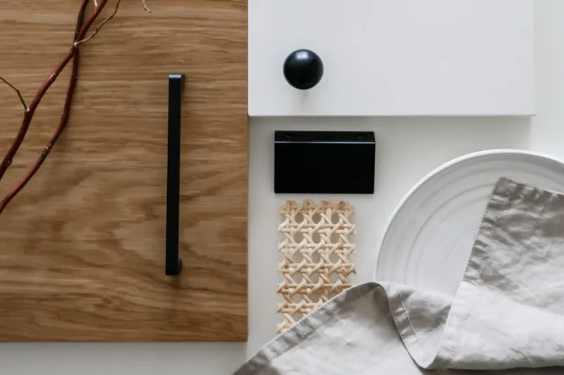 Japandi palette with a wood-grain front, black handle, round black knob, rattan and pale linen