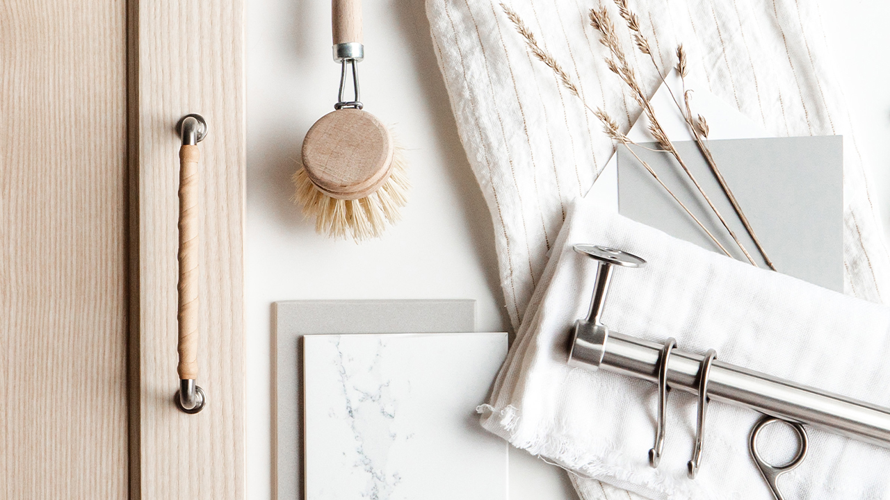 Timeless wooden kitchen with leather handles and stainless steel details.