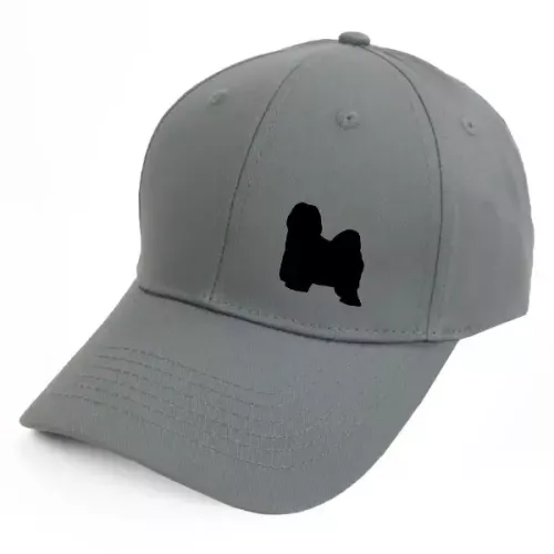 Keps med en Tibetansk Terrier