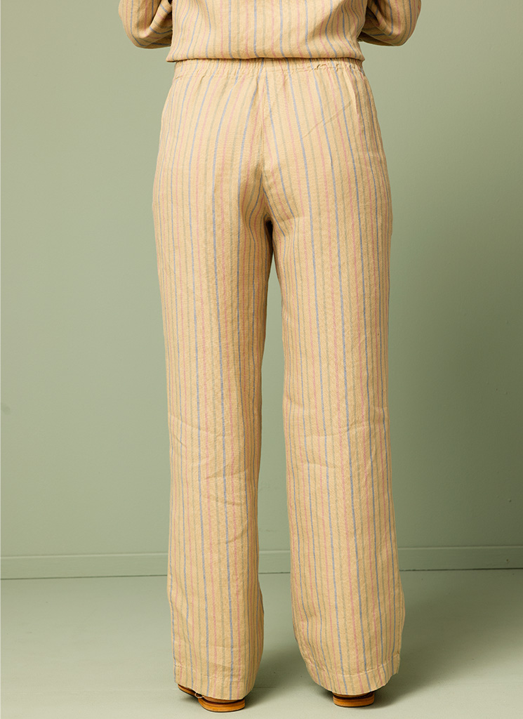 Flerfärgade randiga linnebyxor. Vida byxor i linne med resår i midjan. Beige botten med flerfärgade ränder. K&US Kandus linnekläder Stockholm