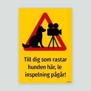 Till dig som rastar hunden här, le inspelning pågår! - Varningsskylt