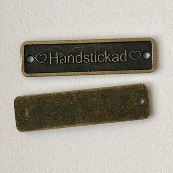 Handstickat - metaltag