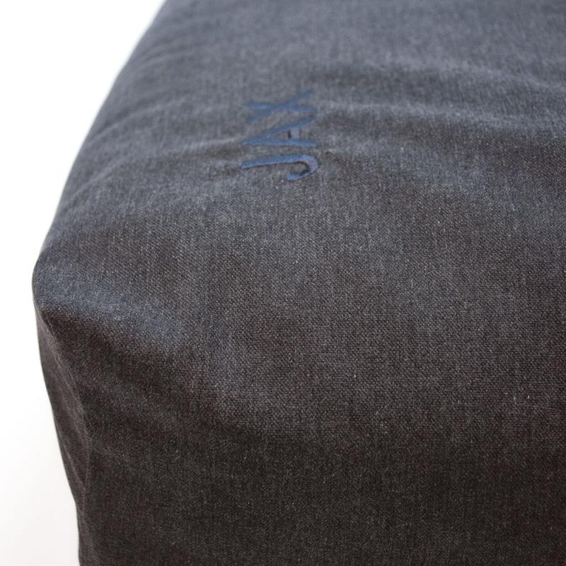 Hörnan på en mörkgrå bäddyna till katt eller hund namnet Jax graverat i blått.