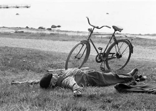 Man sleeping beside bike, Greeting card