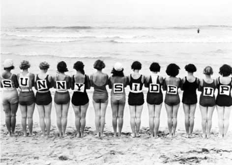 Line of women on beach spelling sunnyside up, Greeting Card