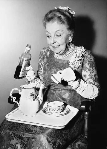 Lady adding gin to her tea, Greeting Card