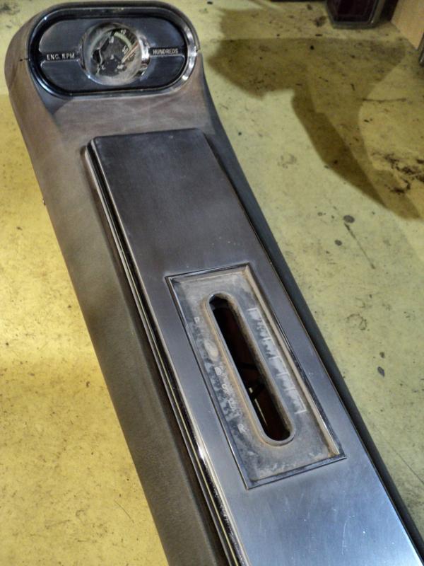 1963   Oldsmobile Starfire    console (tachometer damaged, chromed door has pores, lamp glass at front missing)