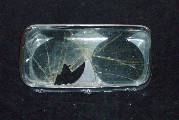 1965 Imperial headlight door left (bad glass, good chrome)