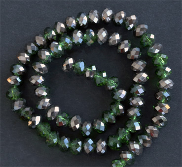 Glaspärlor facetterad rondell 6,5x4,5 mm Grön / mörk silver, ca 65 st