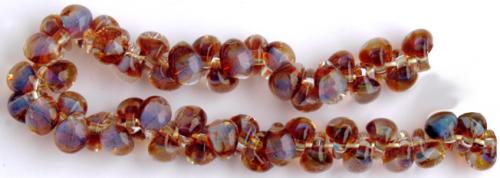 Glasdroppar i en "strand" om ca 25 st. Mörkbärnsten-duvblå