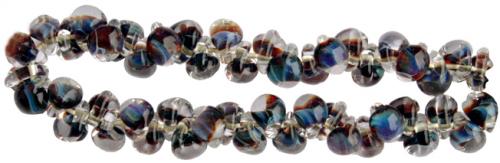 Glasdroppar i en "strand" om ca 25 st. Multiblå-brun