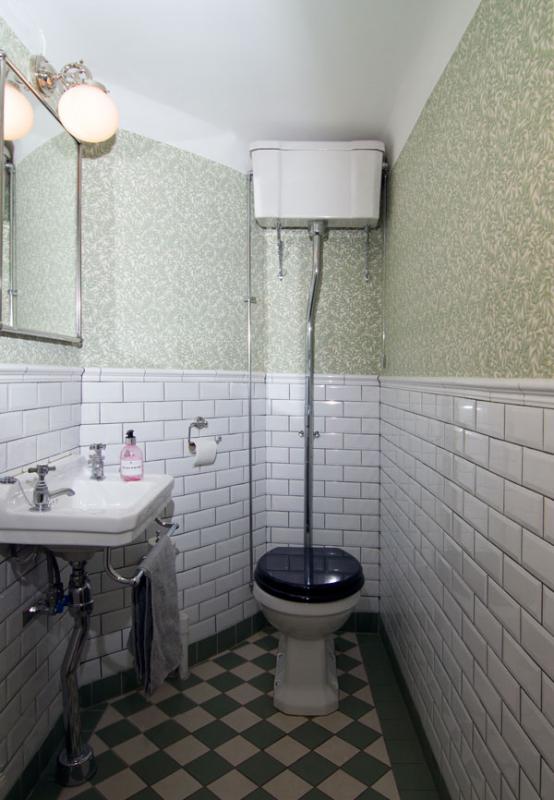 Renovated guest toilet in green, white and black.