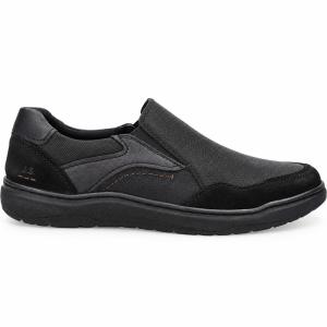 En svart slip-on-sko för herrar från Josef Seibel i profil mot vit bakgrund. Skon är gjord i skinn med detaljer i textil, har elastiska resårband vid vristen samt en robust, svart gummisula.