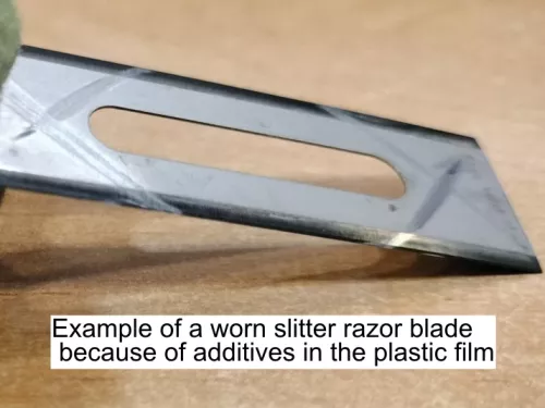 Example of a worn slitter razor blade because of additives in PP blown plastic film - Sollex