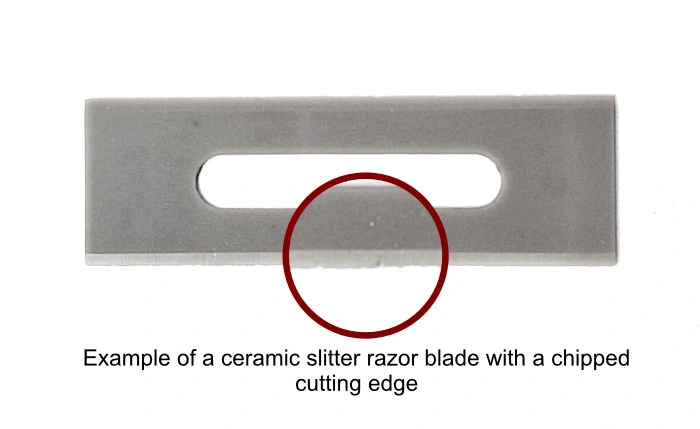 Example of a damaged ceramic slitter razor blade with a chip on cutting edge caused by slitting abrasive plastic film - Sollex blog