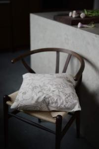 Kuddfodral ELLIE med ett snirklande fantasifullt bladmönster i nougat på beige botten