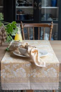 Bordslöpare DANTE, blommig i gult med bård i kortsidorna