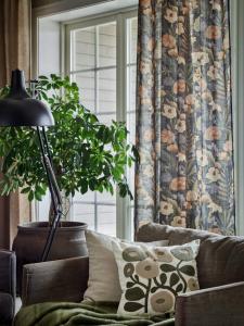 Kuddfodral SABINA i kortklippt "teddy"-kvalité med broderade, tuftade blommor i gröna toner