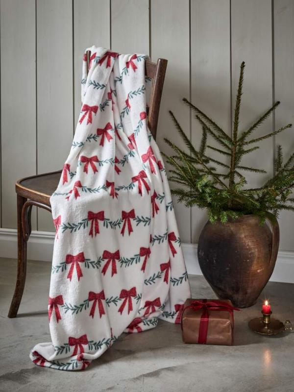 Pläd CHRISTMAS BOW med grangirlanger och röda rosetter på vit botten
