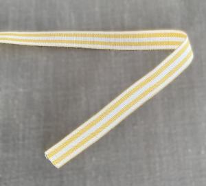 Textilband, vävt randigt i vitt och gult