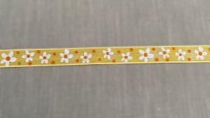 Textilband, gult tunnt band med vita tryckta små blommor