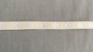 Textilband, ljusgult band med vita broderade små blommor