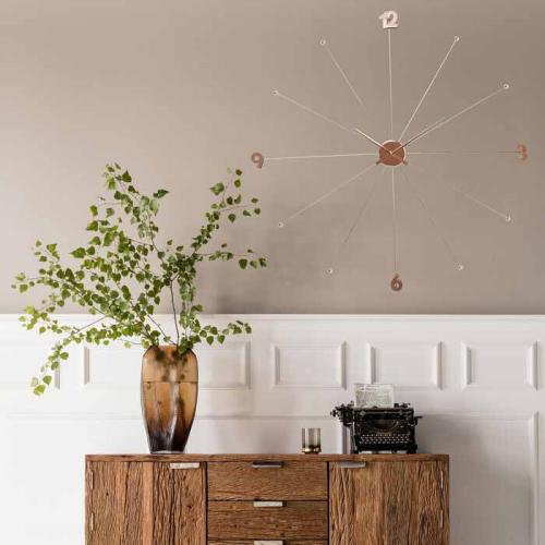 Väggklocka på vägg ovanför skänk